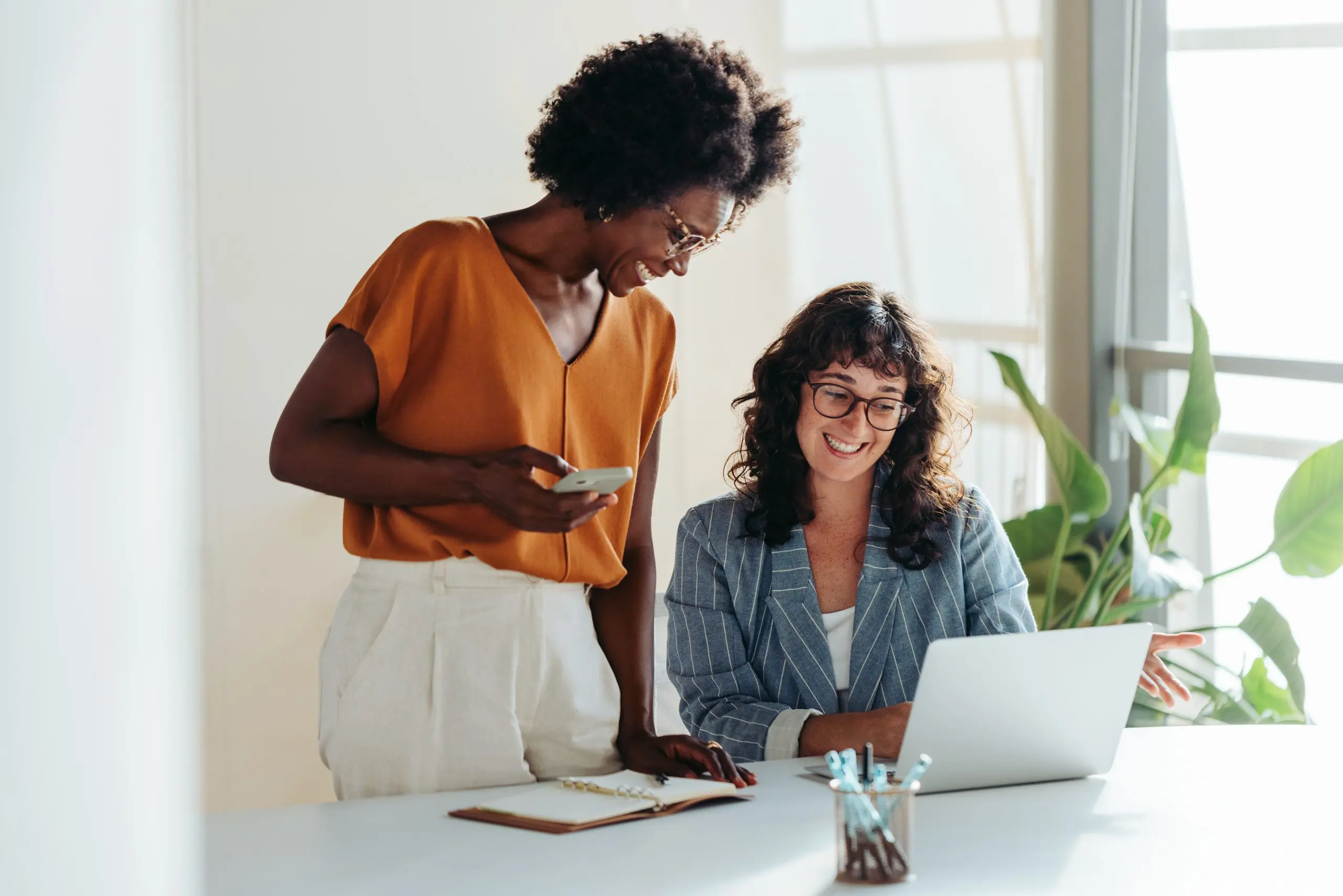 Happy,Professional,Women,Collaborating,With,Enthusiasm,In,A,Modern,Office